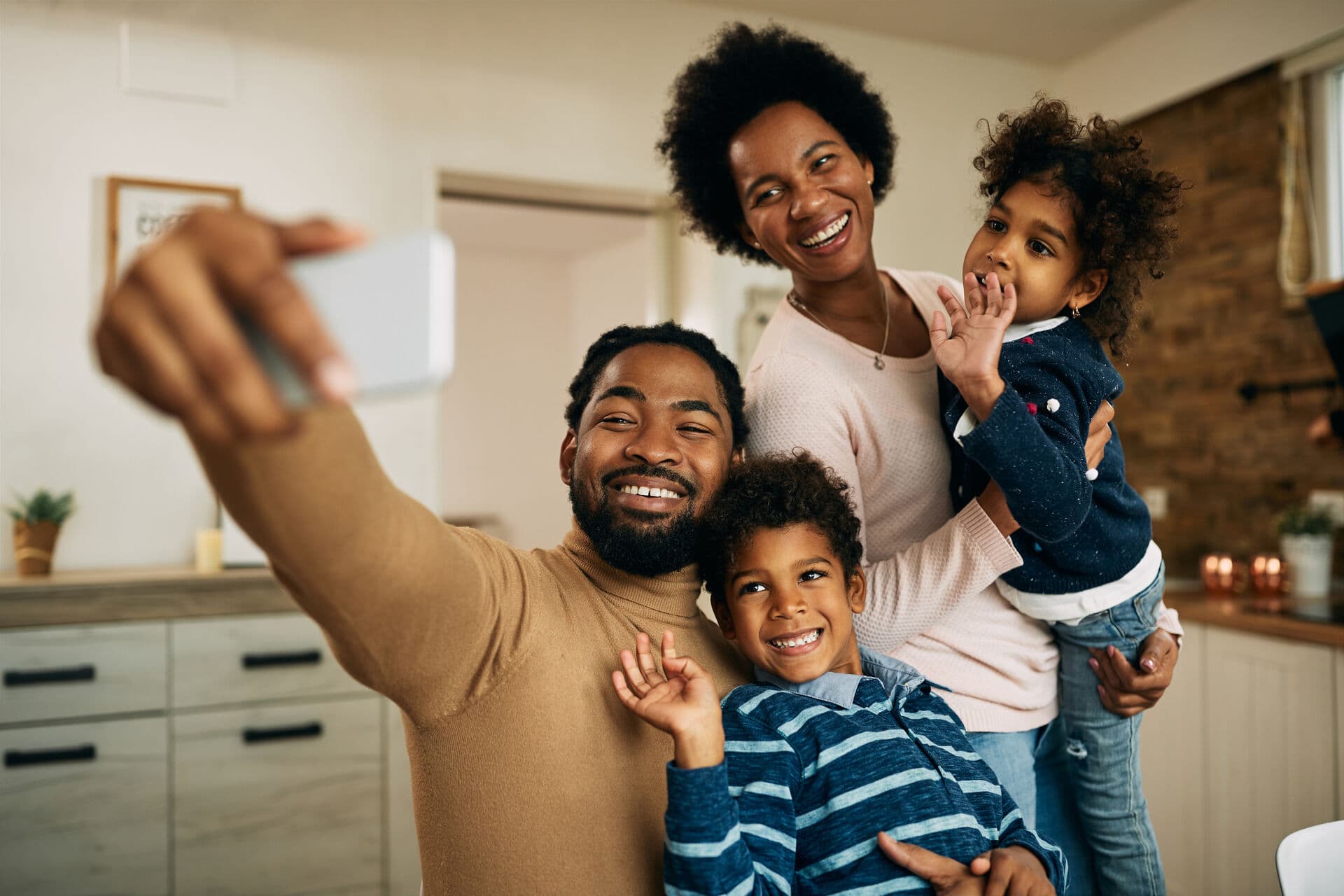 A family taking a photograph together at home